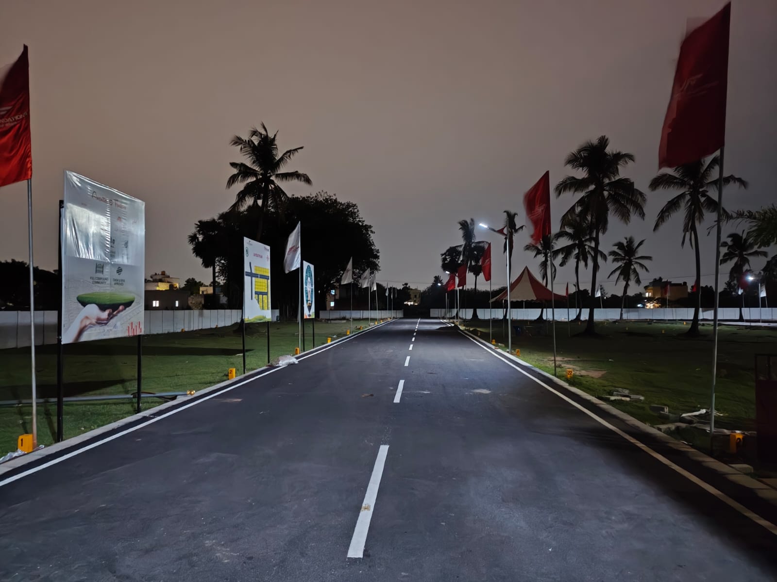 Nexus main internal avenue at night, lit end to end by the layout's own street lighting