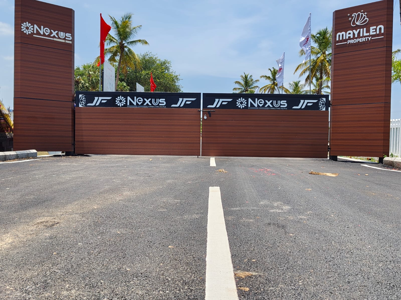 The Nexus entrance gate on a clear morning, flanked by the Nexus and Mayilen Property pylons